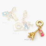 Colgante Viajes Chapa de Oro 25